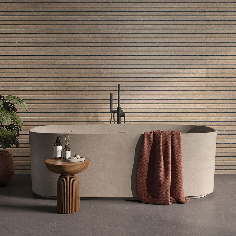Textured linear beige tiles behind modern freestanding bath.