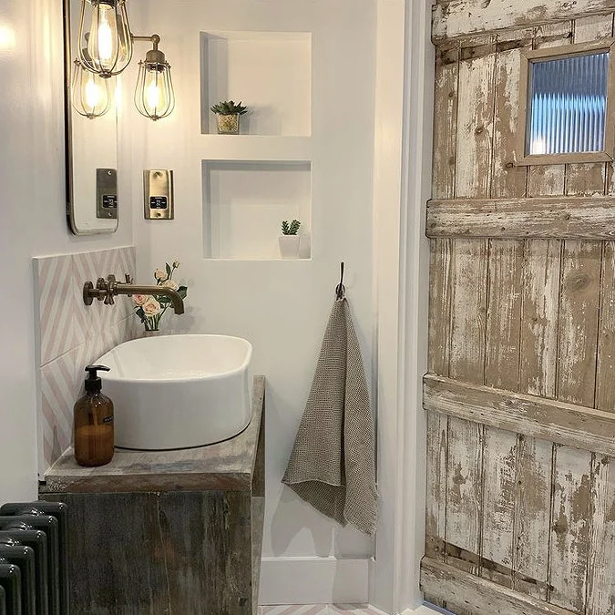 Rustic bathroom with a wooden vanity, vessel sink, and weathered wooden door