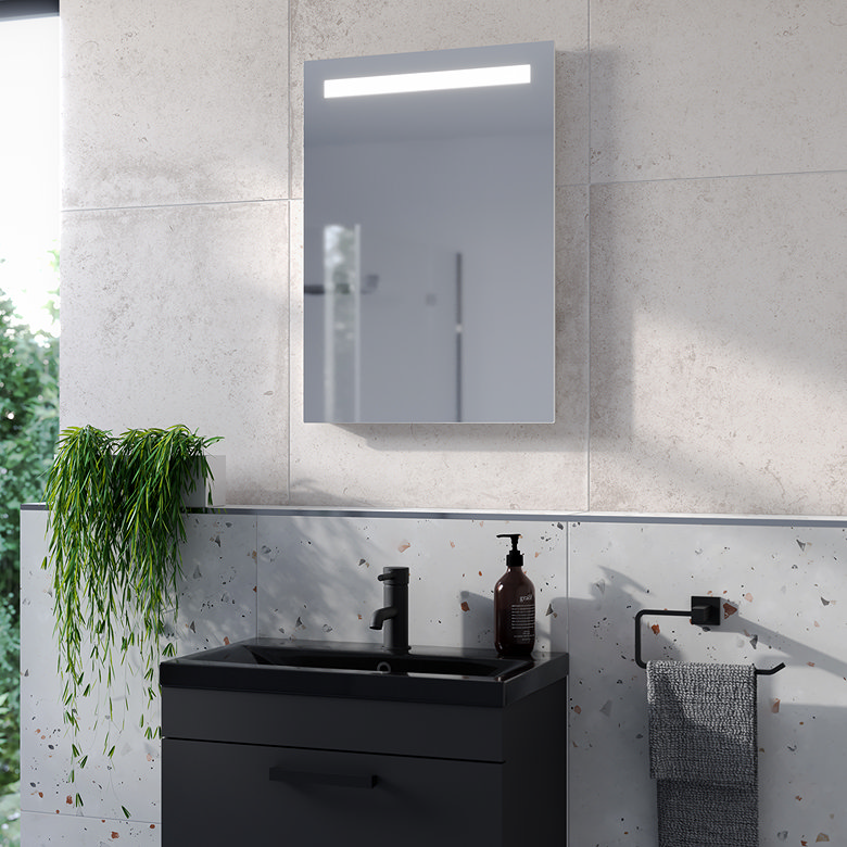 LED illuminated heated bathroom mirror with anti-fog demister above modern vanity basin