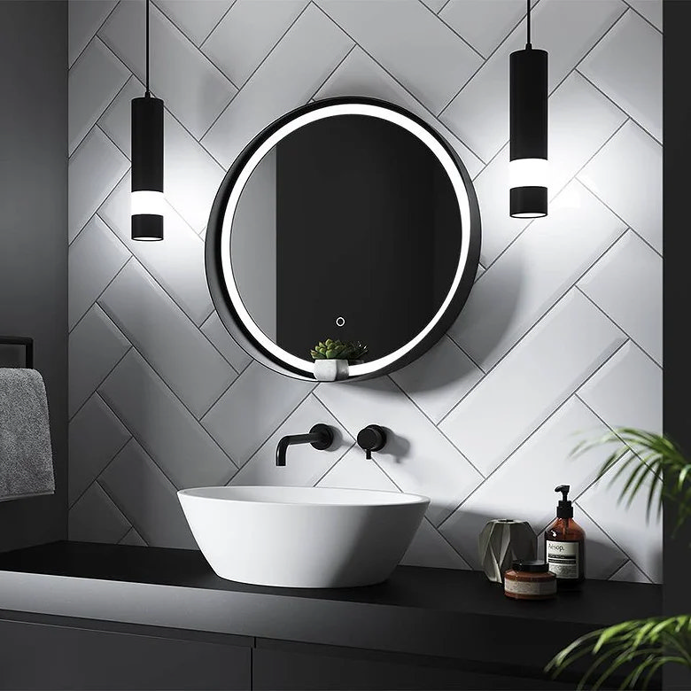 Modern bathroom vanity with round LED mirror, herringbone wall tiles, black tapware and countertop basin