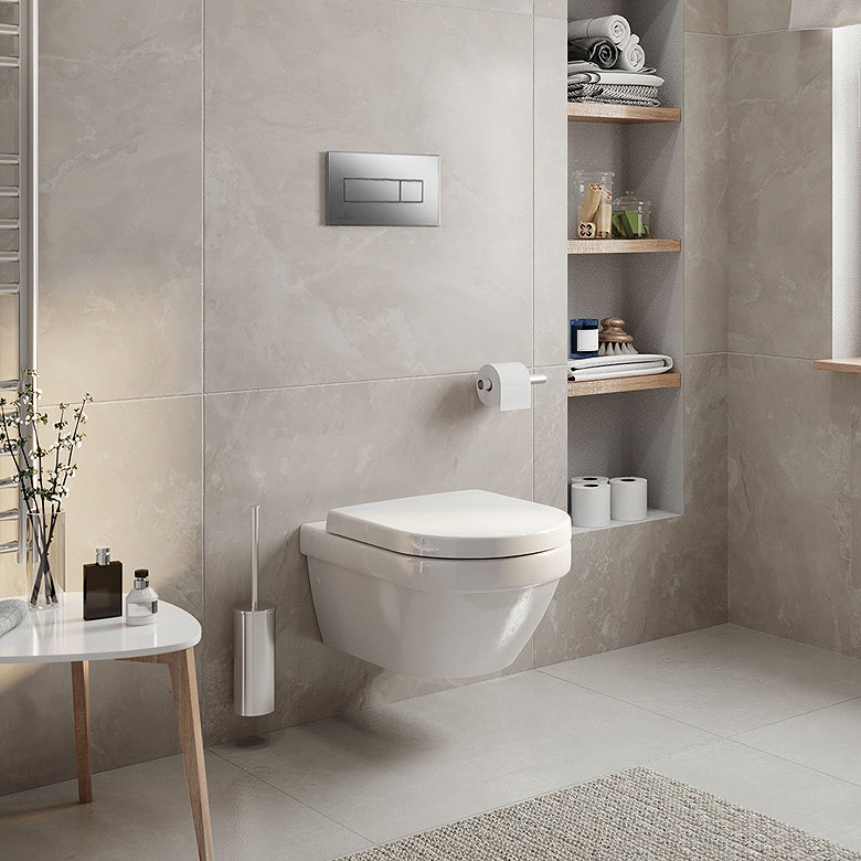White wall hung toilet with concealed cistern and flush plate in a modern tiled bathroom