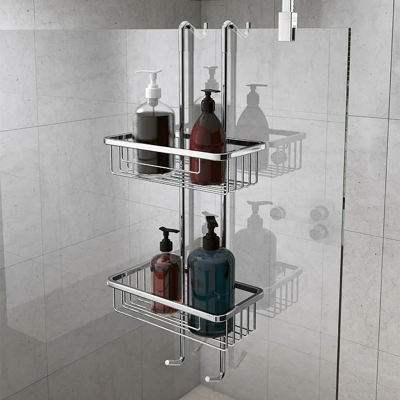 Two-tier chrome shower caddy hanging over a glass shower screen for storing shampoo, soap and toiletries