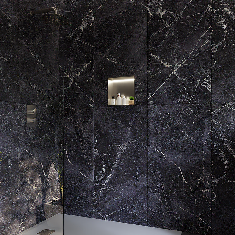 Walk-in shower with a recessed wall niche for storing toiletries against black marble effect tiles