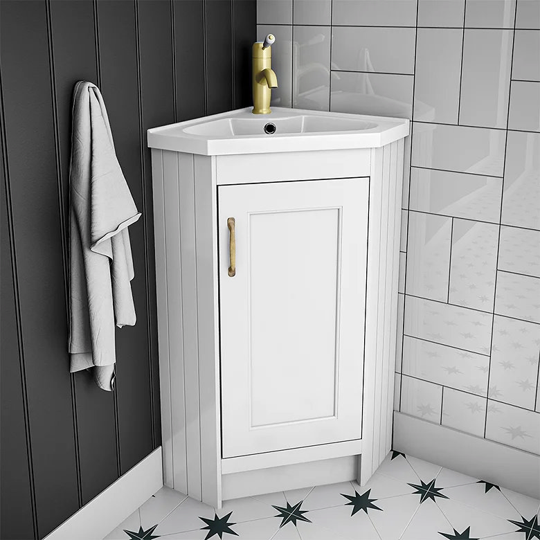 Compact white corner vanity unit with built-in bathroom storage to make use of an unused corner