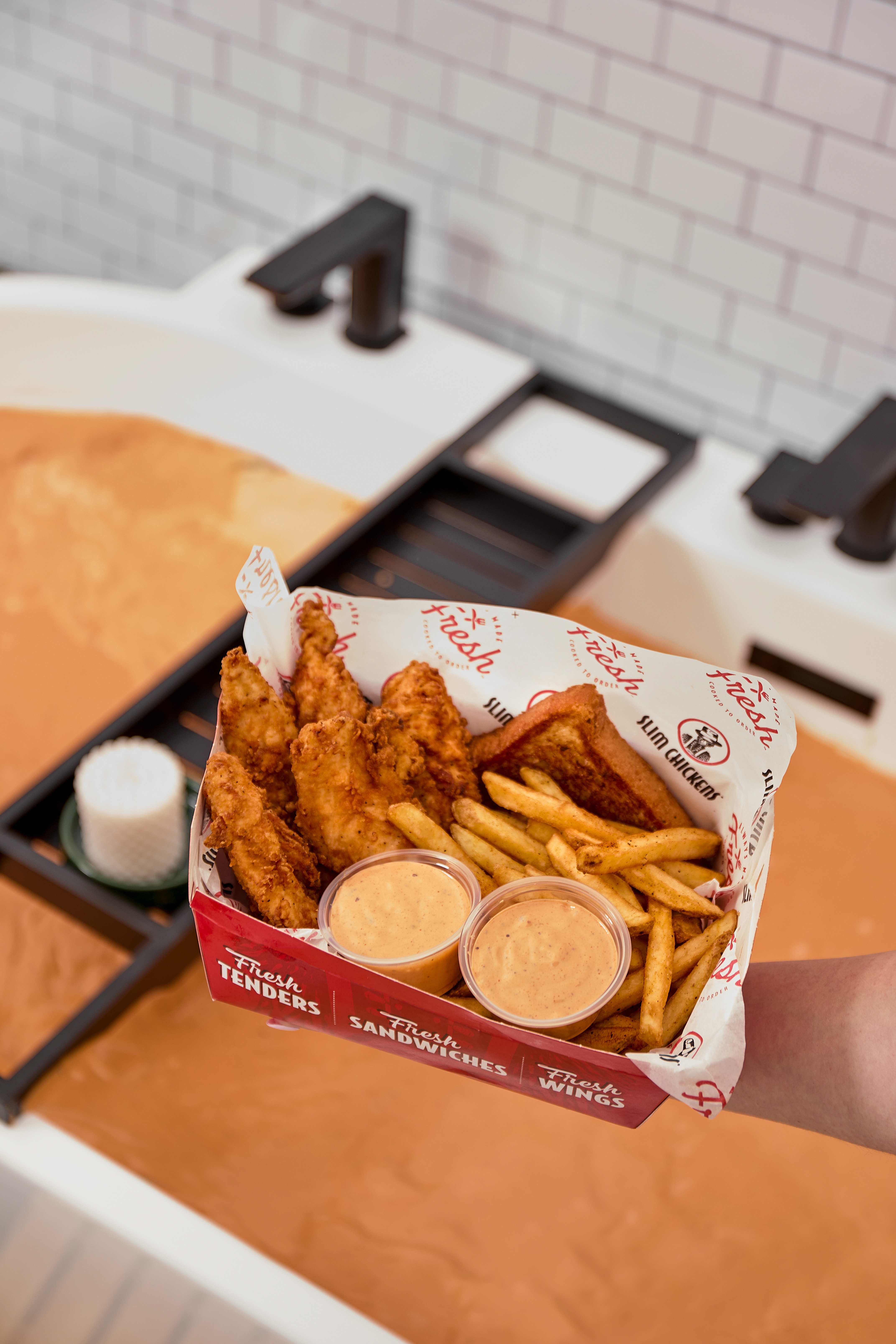 chicken and chips takeaway above bath full of dip