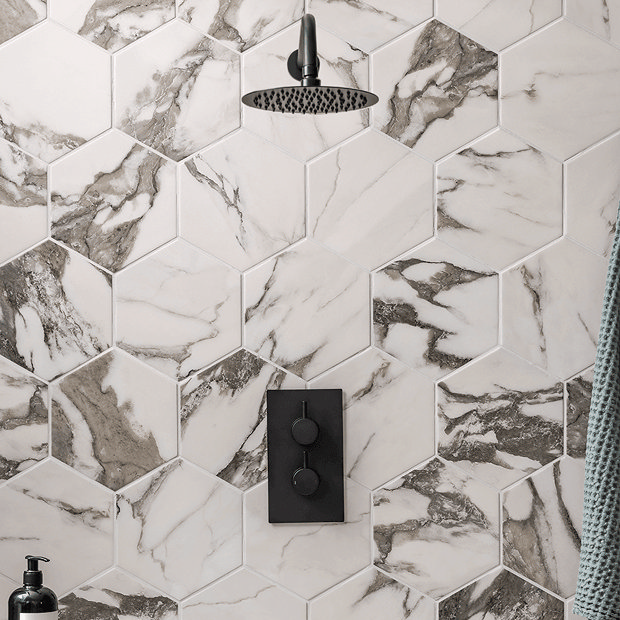 Black shower valve with marble tiles