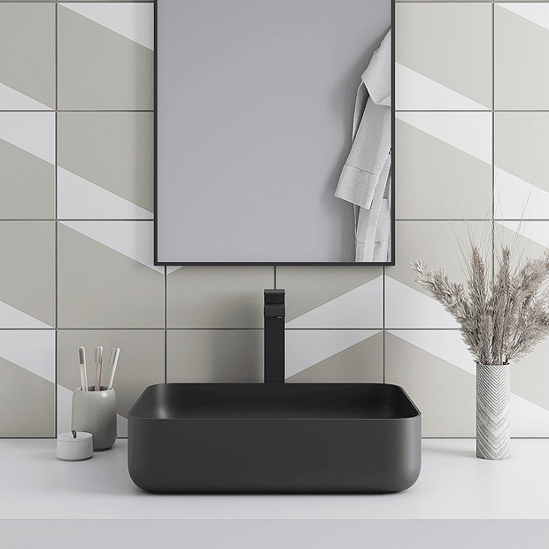 Beige and white tiles with black basin and tap