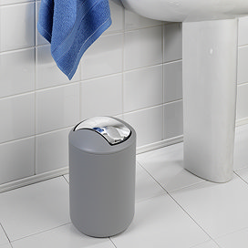 Grey bin in bathroom