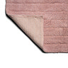 The bottom corner of the Croydex Pink Arched Bath Mat flipped up, showing the anti-slip feature on the underside.