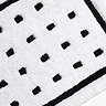 Close up image of the Croydex White and Black Squares Bath Mat showing the small black squares and part of the wider black lined box.