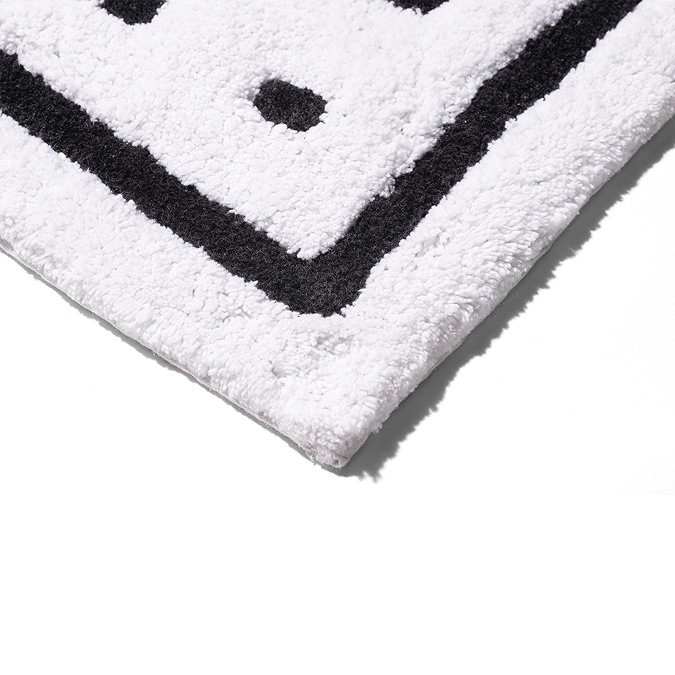 Bottom corner of the Croydex White and Black Squares Bath Mat, pictured on a white background.