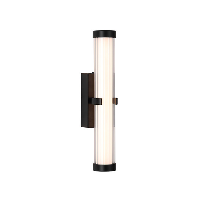 A matt black clamp‑style wall light with a glowing ribbed opal glass tube held in place by a central black metal clamp.