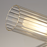 Close‑up of one ribbed clear glass shade from the four‑light ceiling fixture, showing warm illumination inside the textured cylinder.