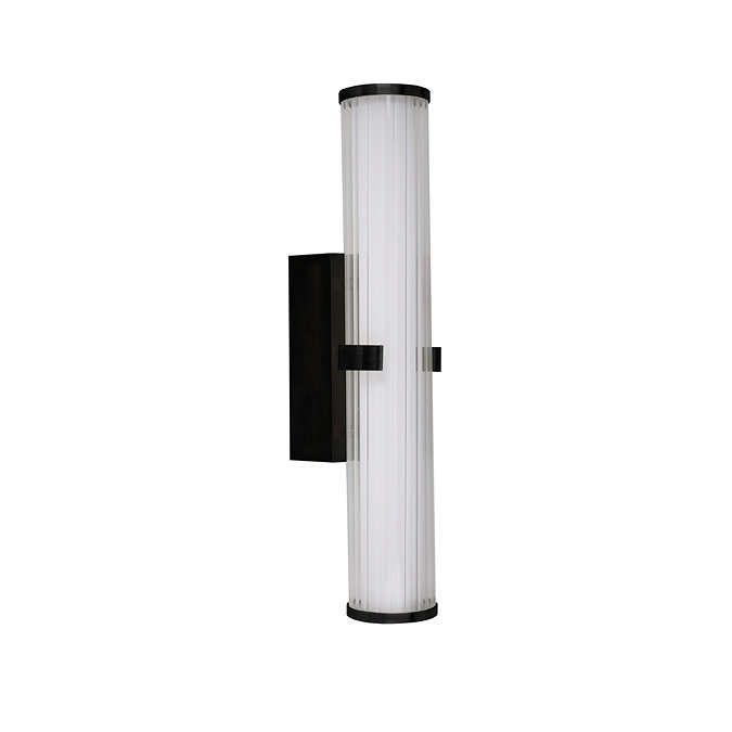 A matt black clamp‑style wall light with a tall ribbed opal glass tube held at the centre by a black metal clamp, shown switched off.