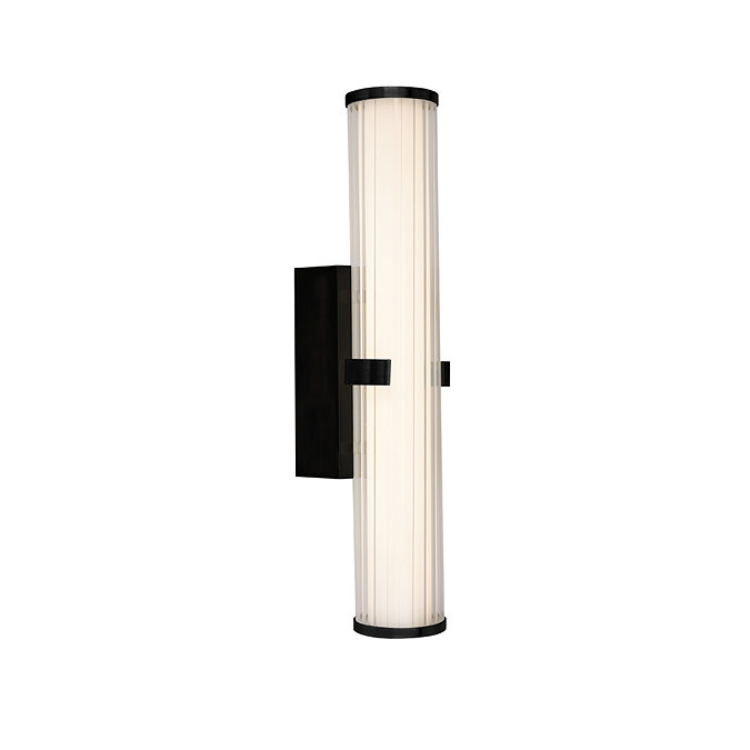 A matt black clamp‑style wall light with a glowing ribbed opal glass tube held in place by a central black metal clamp.