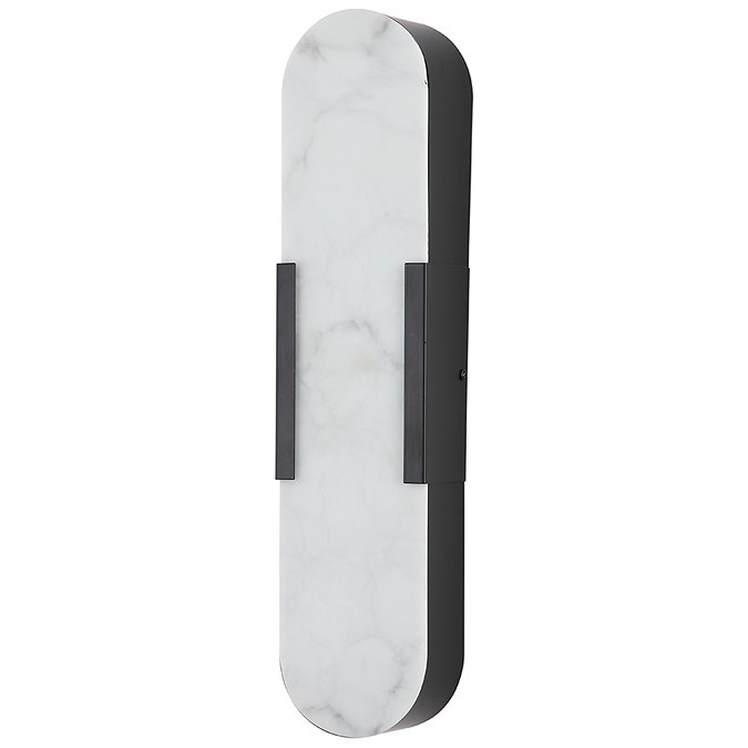 A tall wall‑mounted light with an elongated oval white marble‑effect front panel and matte black sides, shown switched off.