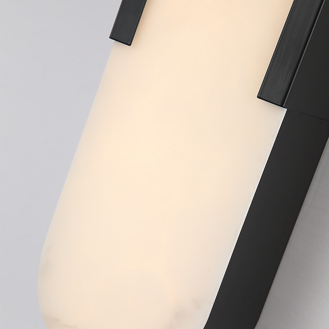 Close‑up view of the glowing marble‑effect diffuser and matte black frame of the tall wall light.