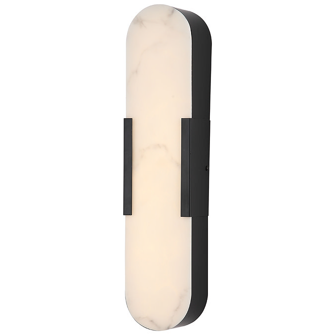 A tall wall‑mounted light with an elongated oval marble‑effect diffuser framed in matte black, glowing softly to show the light is switched on.