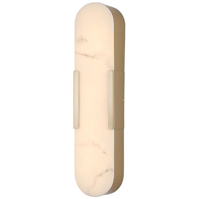 A tall wall‑mounted light with an elongated oval marble‑effect diffuser framed in matt gold, glowing softly to show the light is switched on.