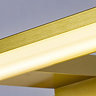 Close‑up of the glowing frosted diffuser and matt gold frame of the slim horizontal mirror light.