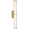 A gold clamp‑style wall light with a glowing ribbed opal glass tube held in place by a central gold metal clamp.