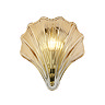 A scallop‑shaped amber glass wall light with a satin brass fitting, shown illuminated to create a warm golden glow through the ribbed glass.