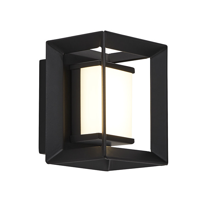 A small black square wall light with an opal acrylic centre glowing softly inside the open metal frame.