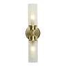 A satin brass up‑and‑down wall light with two clear ribbed glass shades, each glowing softly to show the light is switched on.