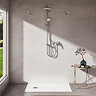 The Ideal Standard Ceratwist T25 Exposed Shower Kit with Fixed Head & Handset - 12 l/min fitted in a modern bathroom on beige tile walls. A large window is pictured to the left of the shower spilling light into the room.