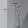 The Ideal Standard Ceratwist T25 Exposed Shower Kit with Fixed Head & Handset - 12 l/min pictured at a side angle in a grey room. The overhead shower head is on, showing how it looks when the water is running.
