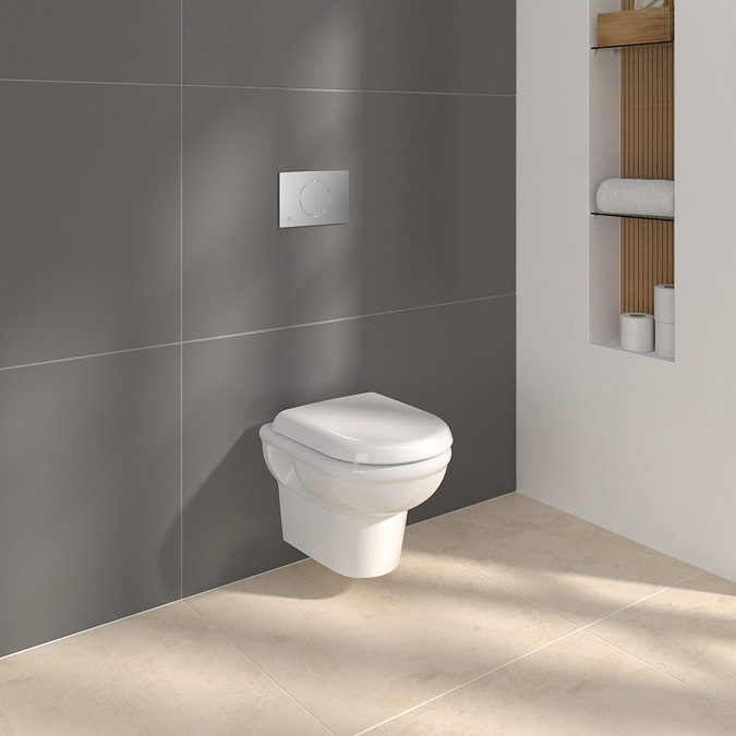 The Ideal Standard Wall-hung Toilet and Chrome Flush Plate fitted into a modern bathroom, WC Frame concealed behind the wall.