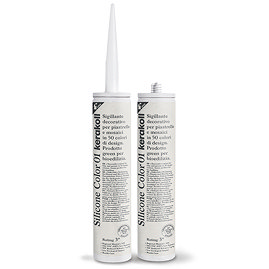 Two Kerakoll Silicone Color white sealant tubes standing upright, one with nozzle attached and one with cap.