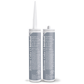 Two Kerakoll Silicone Color blue-grey sealant tubes standing upright, one with nozzle attached and one with cap.
