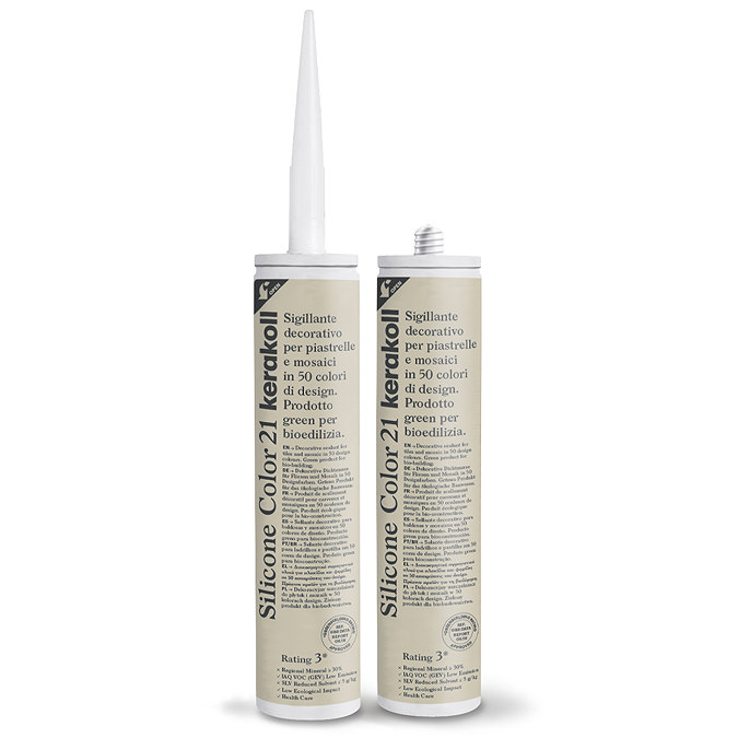Two Kerakoll Silicone Color beige sealant tubes standing upright, one with nozzle attached and one with cap.