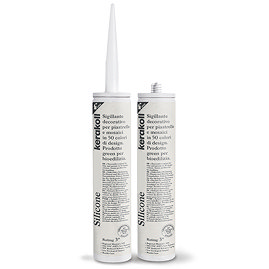 Two Kerakoll Silicone transparent sealant tubes standing upright, one with nozzle attached and one with cap.