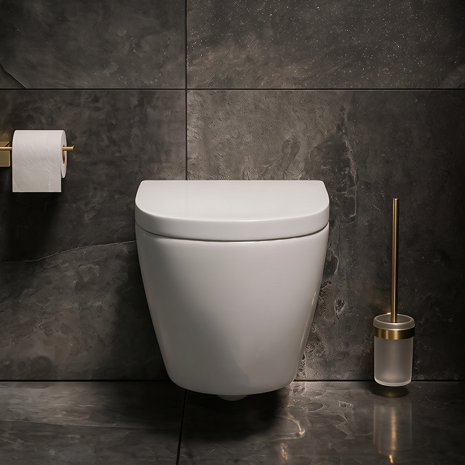 Pavilion Round Rimless Wall Hung Toilet with Soft-Close Seat, Brushed Brass Hinges Lifestyle Front