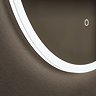 Close up of the bottom corner of the Roxbury Illuminated Round Mirror, showing the light strip's cool-toned glow.