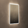 The Roxbury 600 x 800mm Illuminated Rectangular Mirror with Demister Pad pictured on a plain beige wall, showing the mirror omitting a bright, cool glow.
