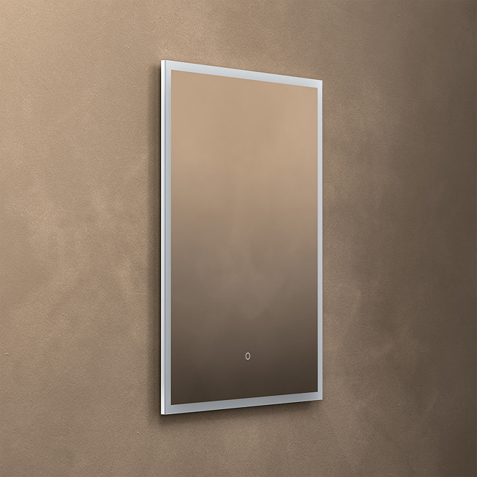 The Roxbury 600 x 800mm Illuminated Rectangular Mirror with Demister Pad pictured on a plain beige wall, showing the mirror light turned off.