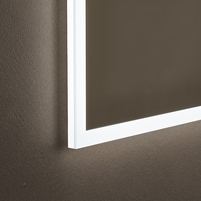 Close up of the bottom corner of the The Roxbury 600 x 800mm Illuminated Rectangular Mirror, showing the light strip's cool-toned glow.
