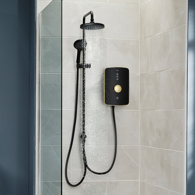 Triton Amala DuElec electric shower installed in a modern bathroom setting, showing the shower unit alongside the rainfall and handheld shower heads.