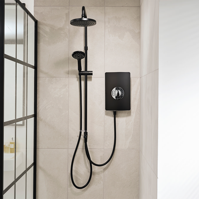 Triton Aspirante DuElec electric shower installed in a modern bathroom setting, showing the shower unit alongside the rainfall and handheld shower heads.
