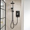 Triton Aspirante DuElec electric shower installed in a modern bathroom setting, showing the shower unit alongside the rainfall and handheld shower heads.