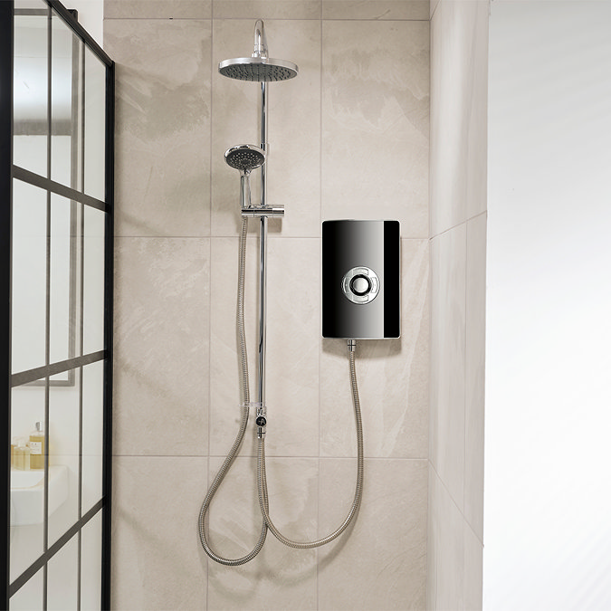 Triton Aspirante DuElec electric shower installed in a modern bathroom setting, showing the shower unit alongside the rainfall and handheld shower heads.