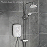 Triton DuoSwitch dual-outlet shower kit in white and chrome installed with a compatible electric shower unit shown for illustration; rainfall and handheld shower heads mounted on a rigid riser rail.